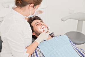 young man and woman in a dental examination at dentist